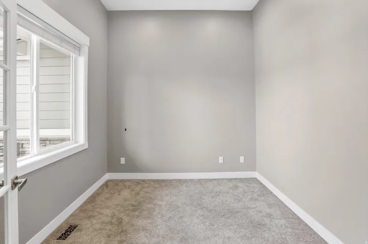 Neutral wall paint, plush carpet flooring, white trim, recessed lighting, and a window with blinds