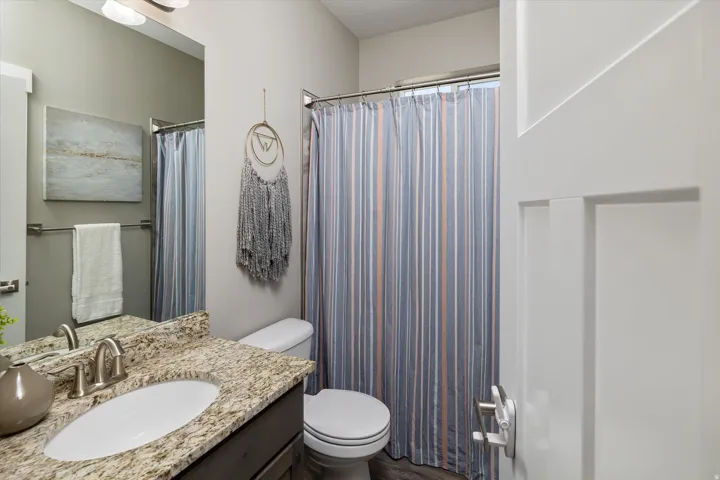 Granite-style countertop with an undermount sink, brushed nickel faucet, and a panel-style door