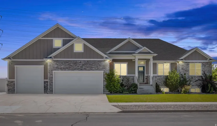 Stone and siding exterior with a multi-car garage