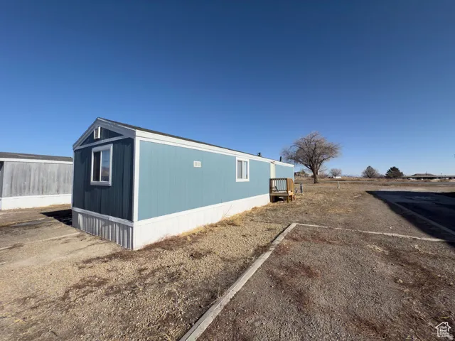 Light blue siding with white trim and a small wooden porch