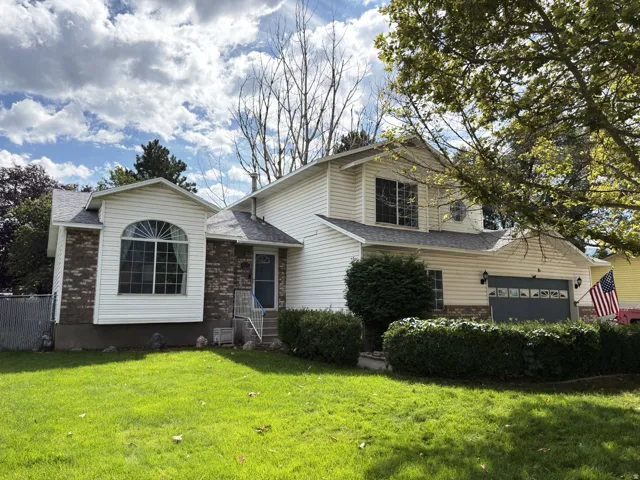 Two-story exterior with white siding and brick accents