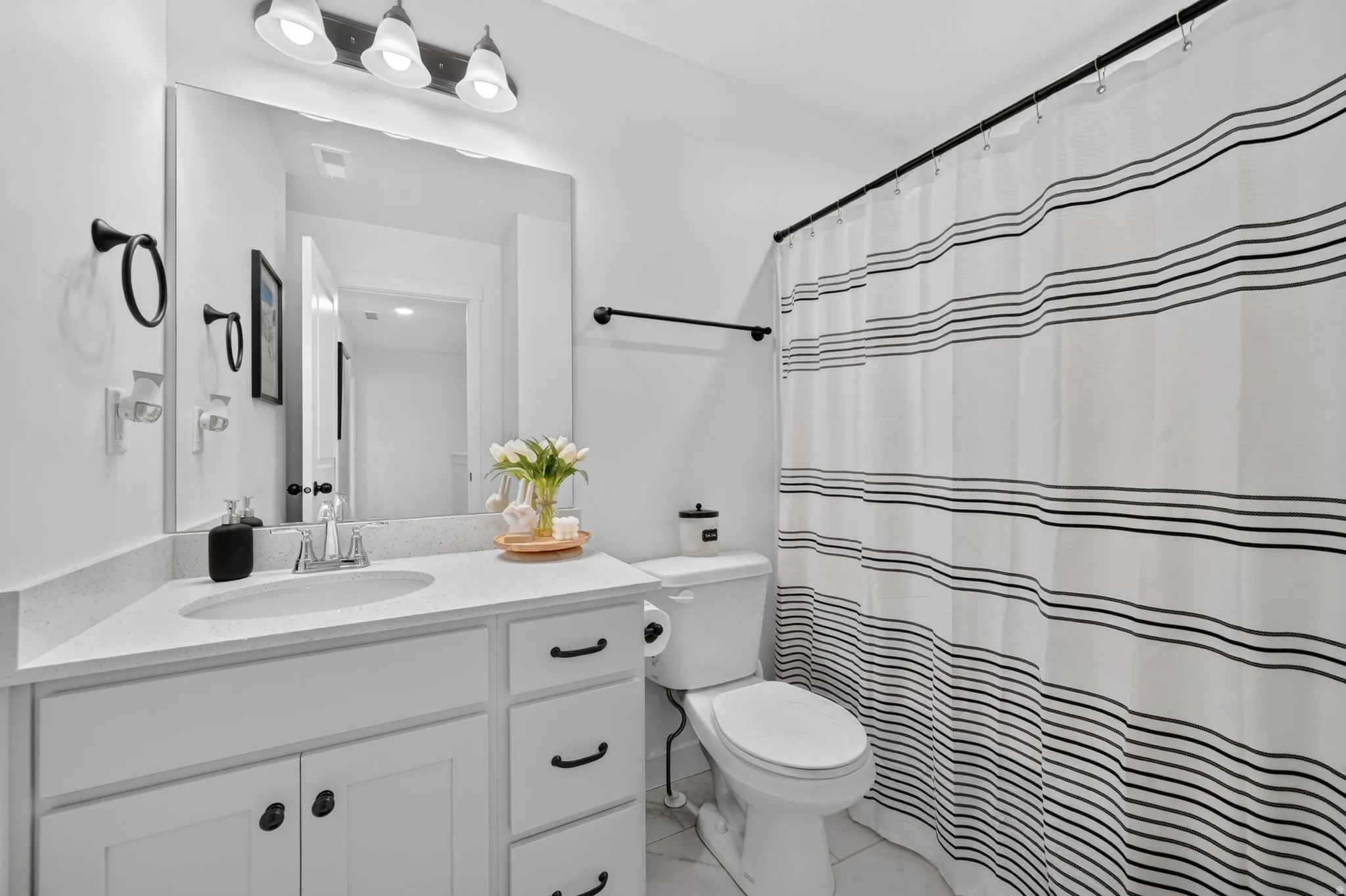 White vanity with an integrated sink and light-toned countertop