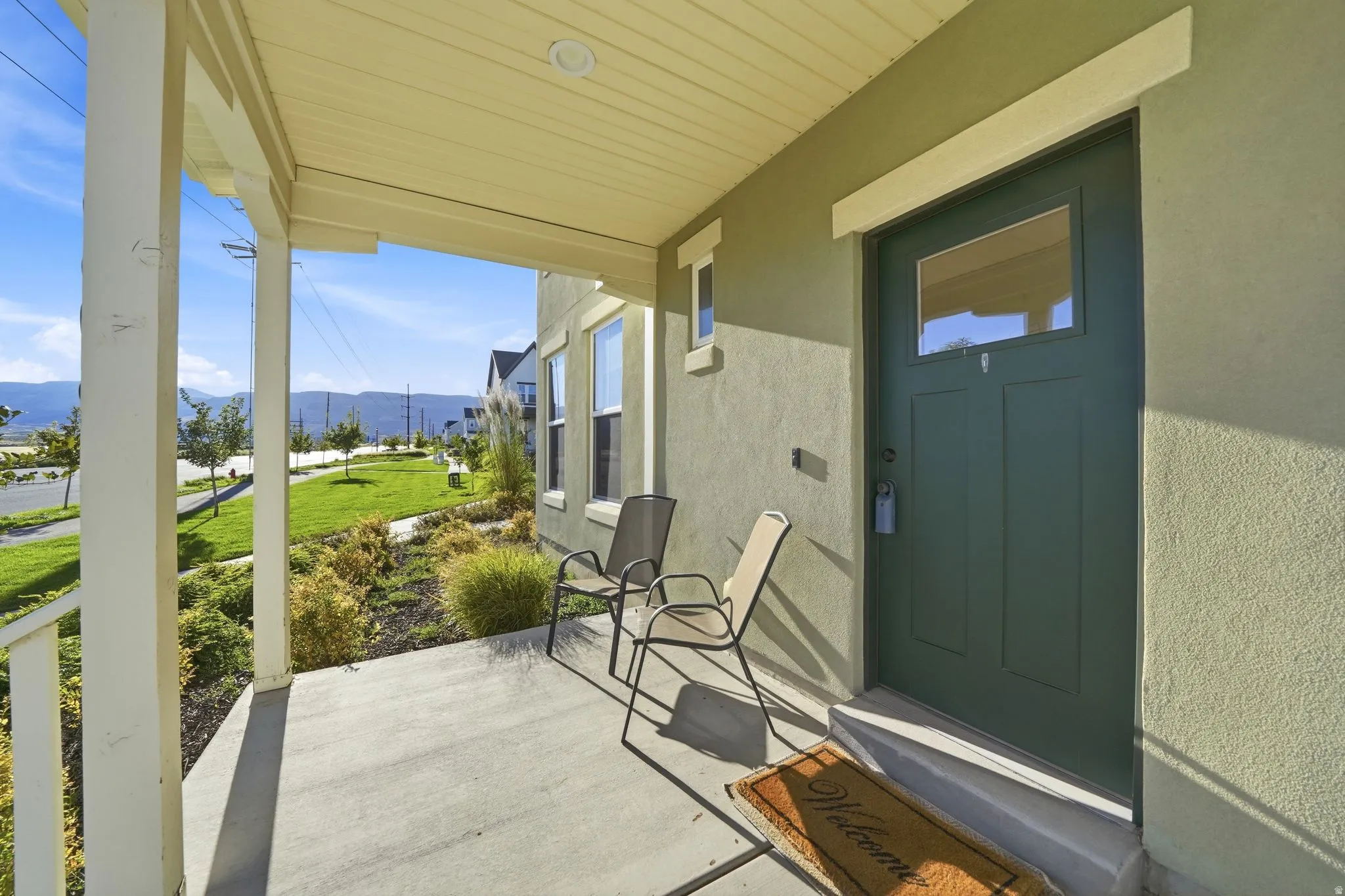 Covered concrete front porch with mountain views