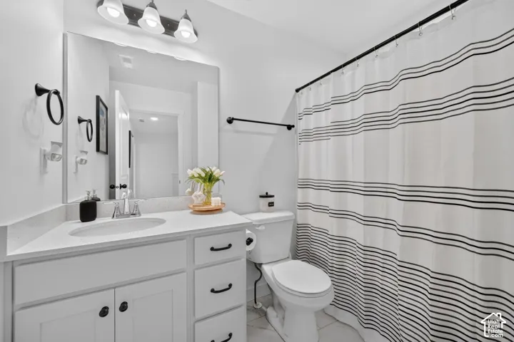 White vanity with an integrated sink and light-toned countertop