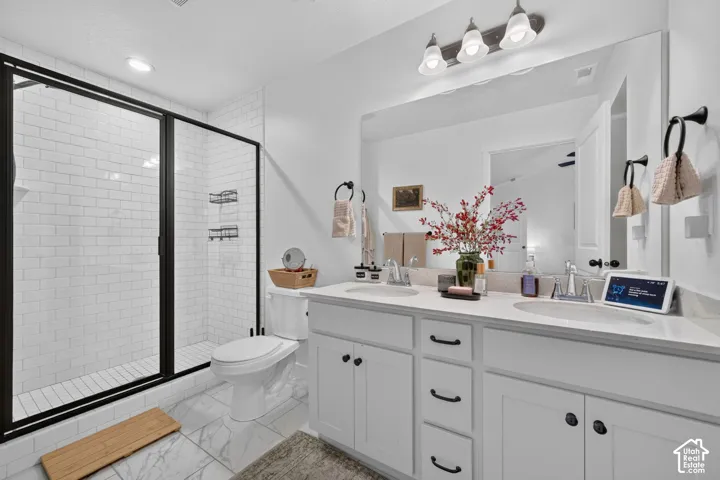 Dual vanity with undermount sinks, white cabinetry, and a full-width mirror