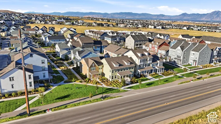 Residential neighborhood with varied architectural styles, green spaces, and paved roadways