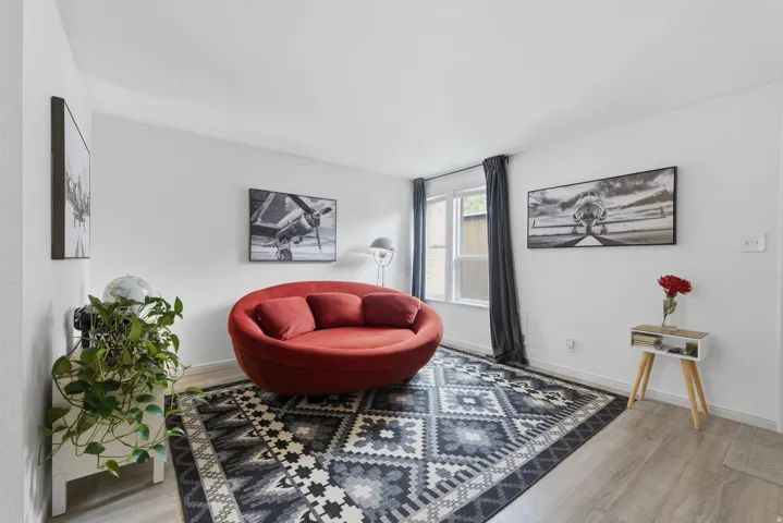 Hard-surface flooring, neutral wall tones, and a window with curtains