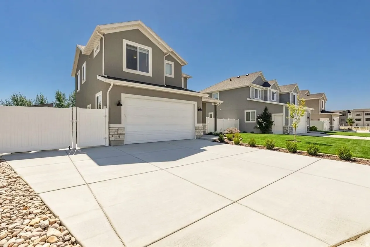 Grey stucco exterior with white trim details