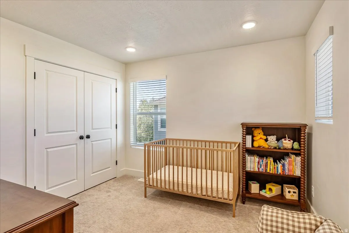 Neutral wall color, recessed lighting, and carpeted flooring