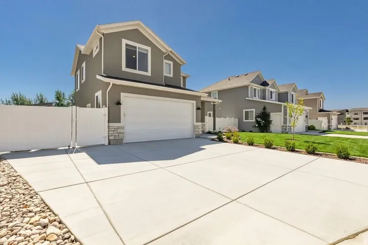 Grey stucco exterior with white trim details
