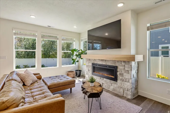Stone-clad fireplace with wood mantel and electric insert