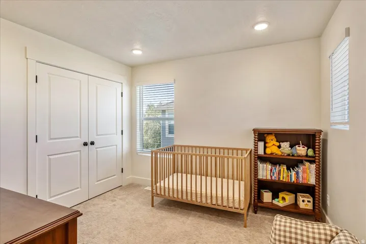 Neutral wall color, recessed lighting, and carpeted flooring