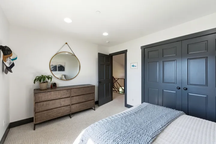 Recessed lighting and light-toned carpeting complement the contrasting dark trim
