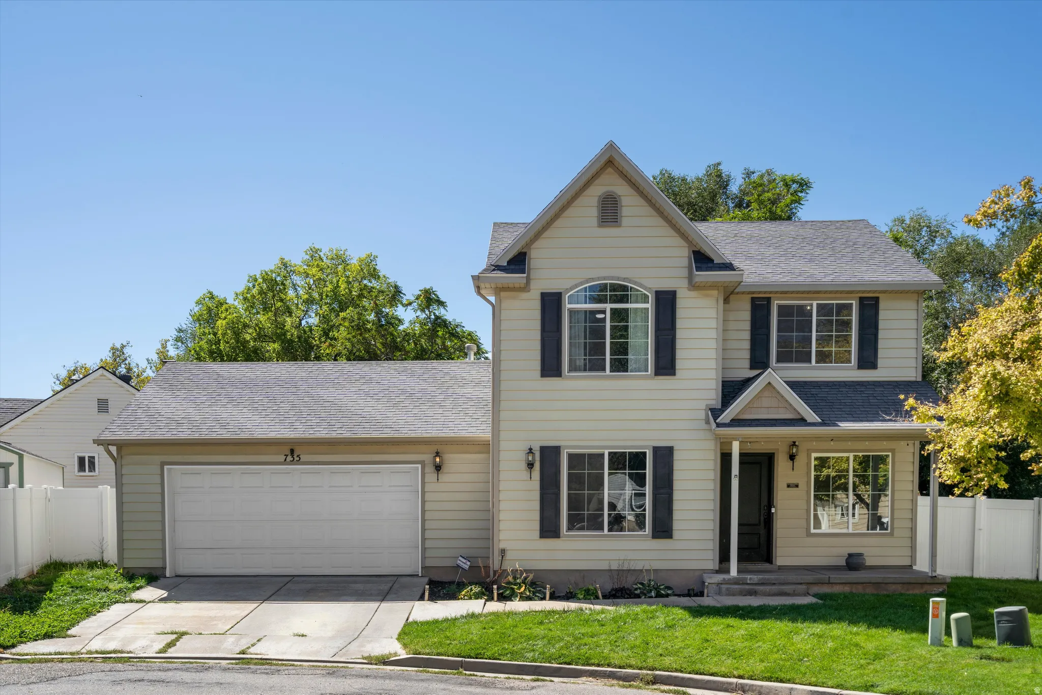 Two-story home with a two-car garage, front porch, and a dormer window