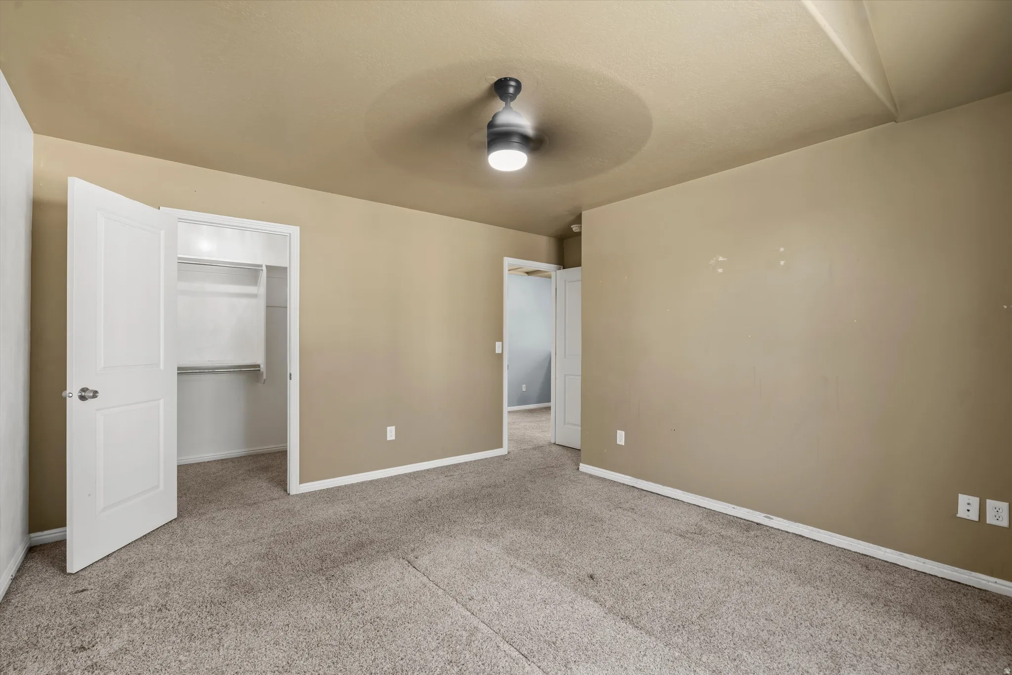 Recessed ceiling fan, carpeted flooring, white trim, and a built-in closet with shelving
