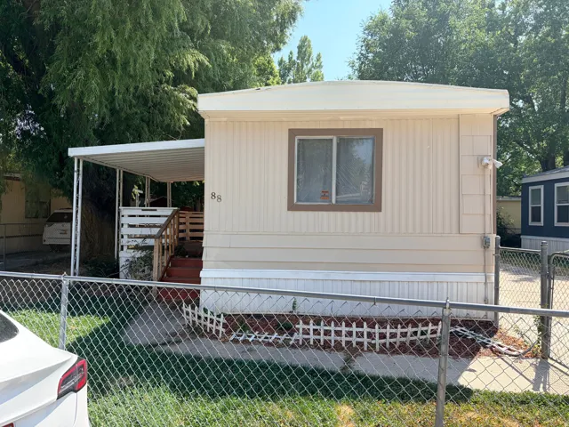Beige horizontal siding exterior with brown trim window