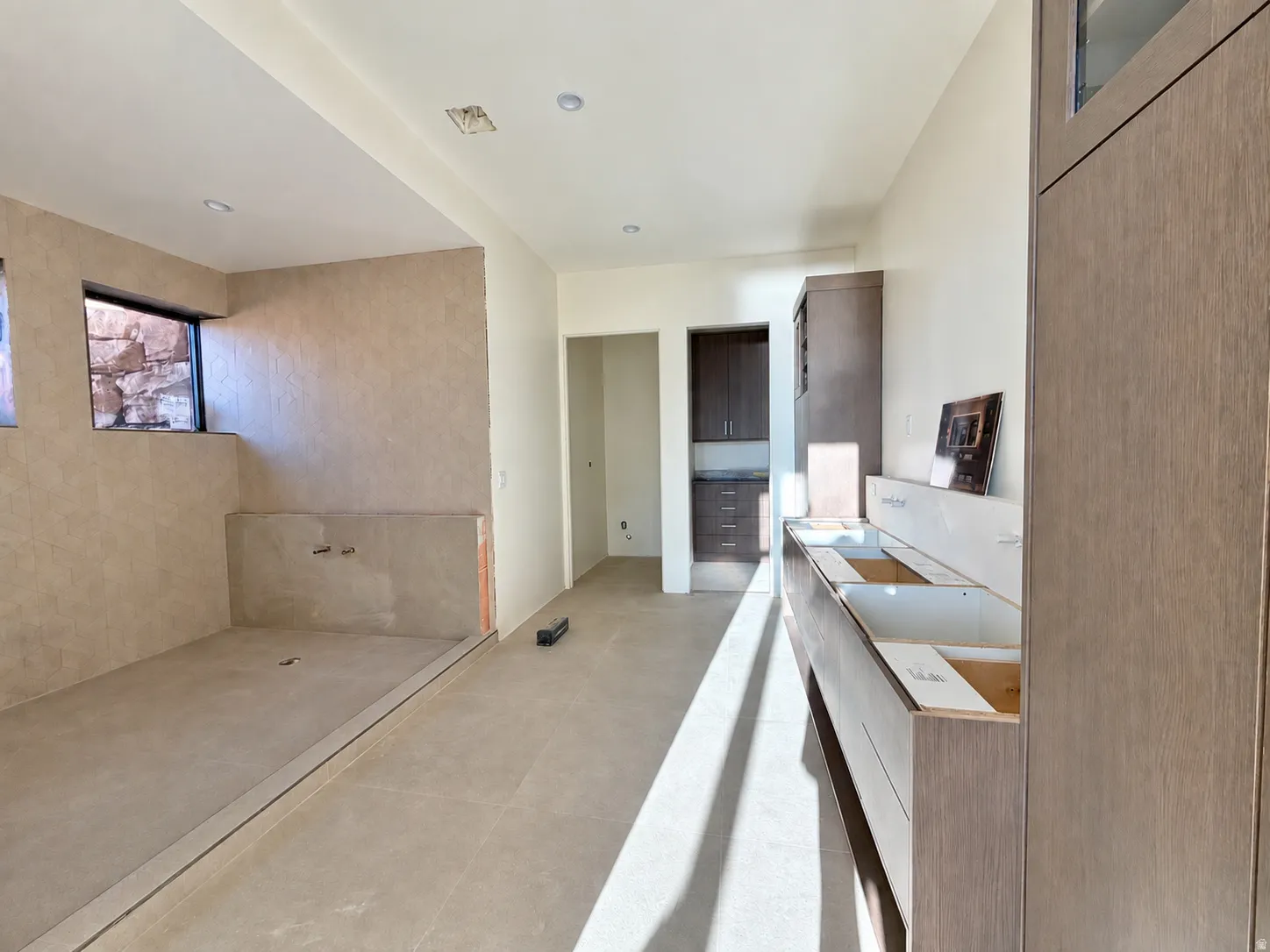 Recessed lighting, wood-finish cabinetry, tiled flooring, and a built-in shower area wet room