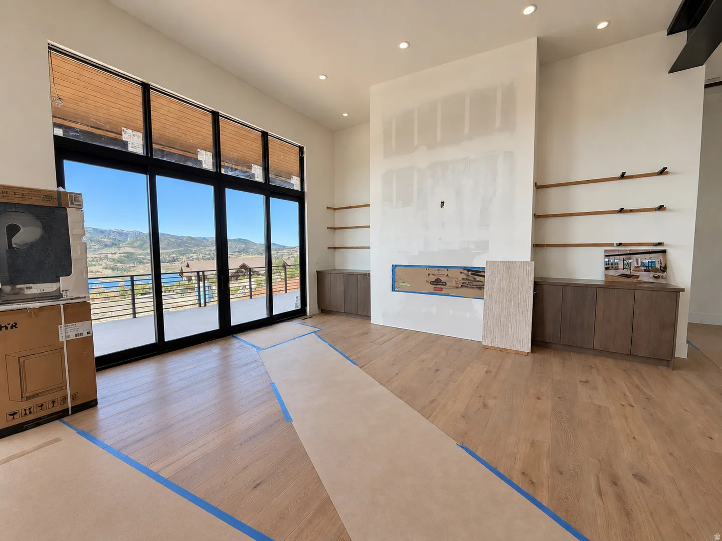 Expansive full-height windows, a built-in fireplace and cabinetry