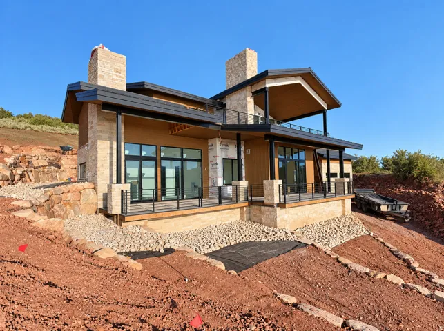 Stone and wood-finish exterior with multiple balconies and a covered patio