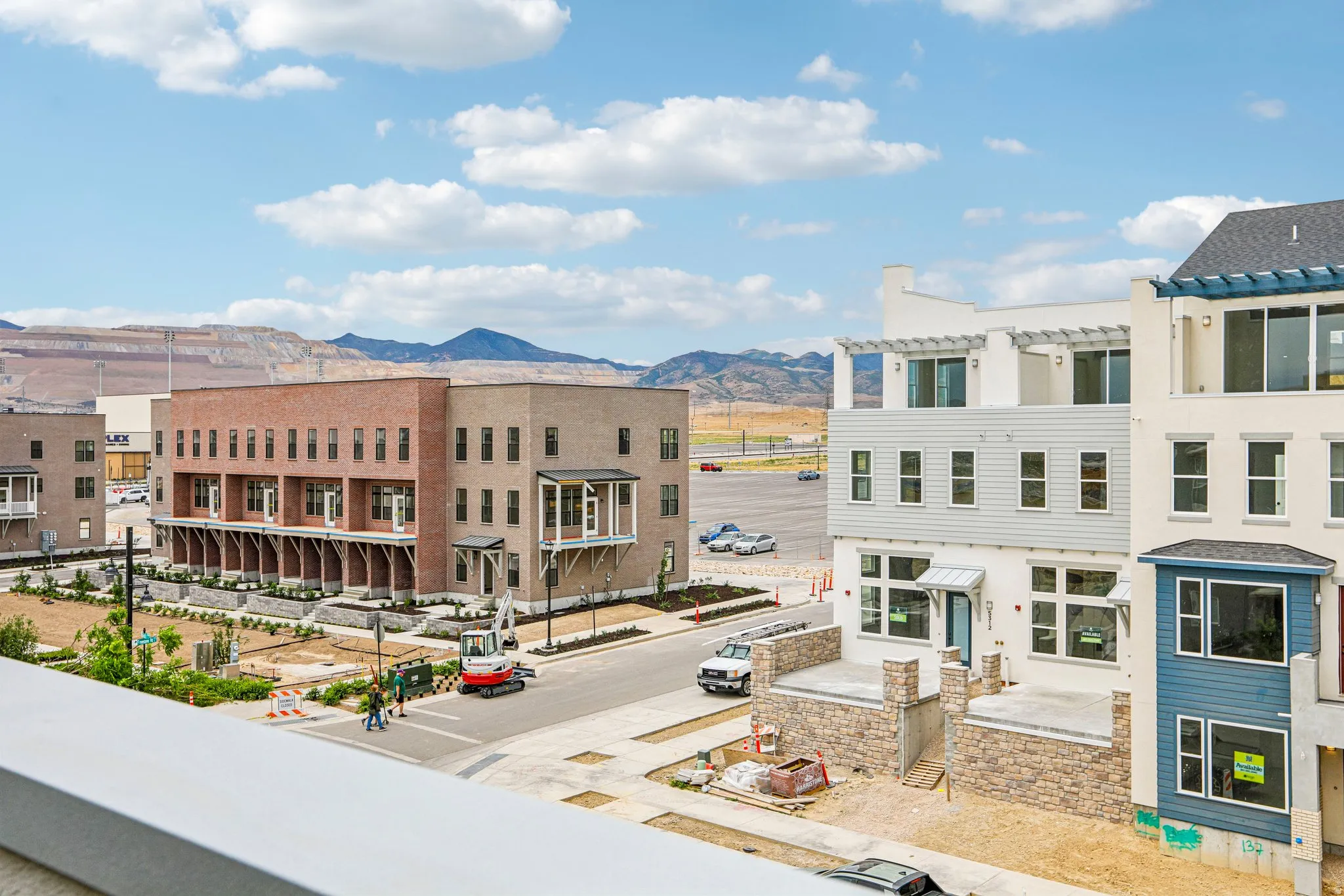 Newly constructed townhomes featuring multi-story designs with brick and siding exteriors