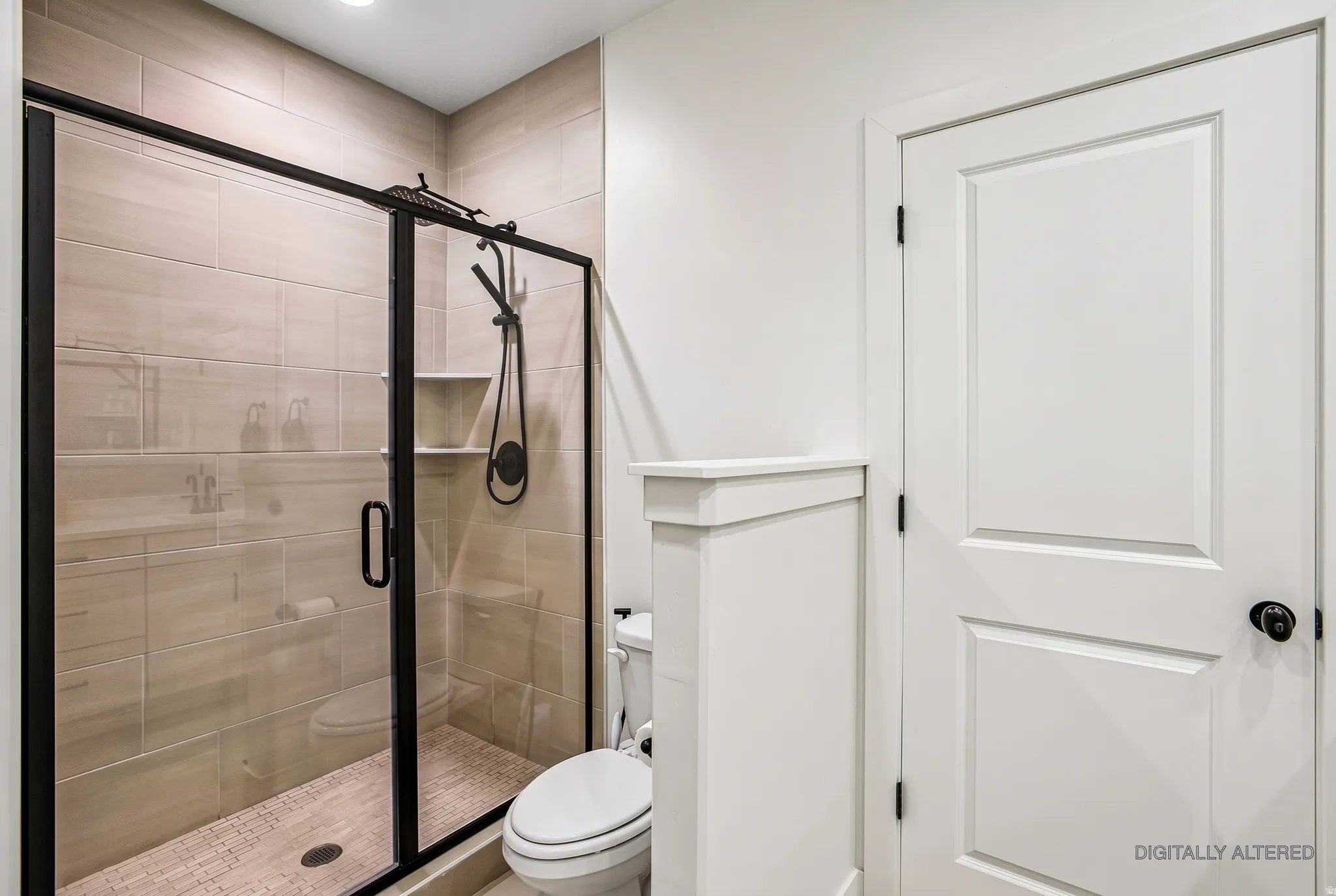 Enclosed shower with matte black fixtures, tile surround, recessed shelf, and tiled shower pan