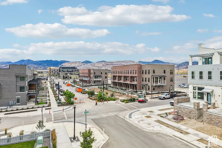 Modern multi-story buildings featuring varied exterior finishes including brick, horizontal siding, and stone accents