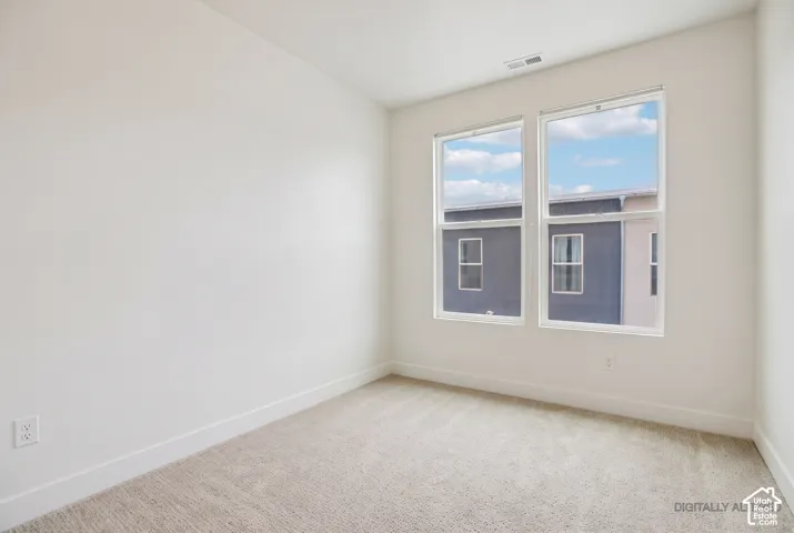Light-colored carpeting with white walls and trim