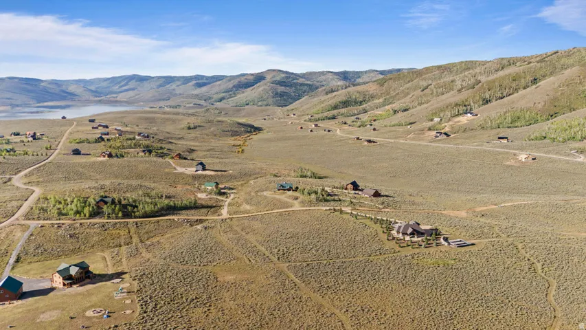 Expansive rural landscape with distant mountains and a body of water