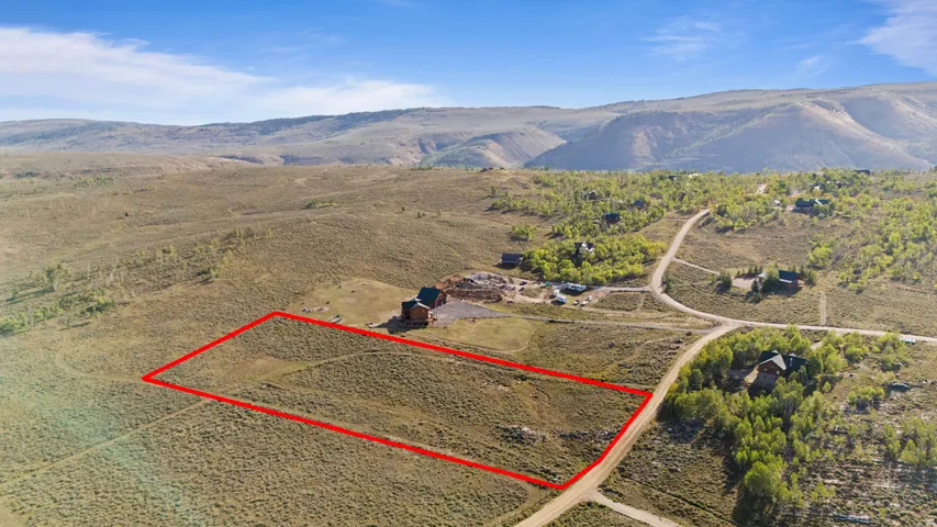 Expansive undeveloped lot featuring natural vegetation and a mountain backdrop