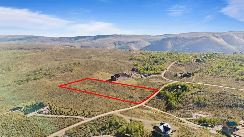 Expansive undeveloped lot featuring a natural landscape and distant mountain ranges