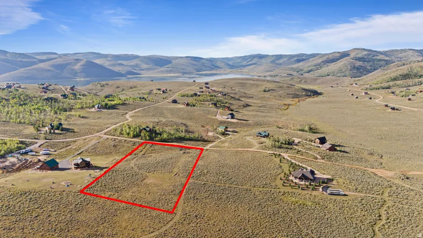 Expansive land parcel featuring natural terrain and distant mountain ranges