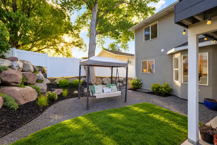 Manicured lawn area with a gravel border and a rock garden