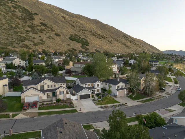 Aerial perspective showcasing the neighborhood setting with a prominent mountain backdrop and paved streets