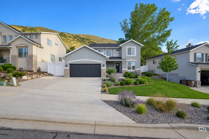 Light gray stucco exterior with stone accents