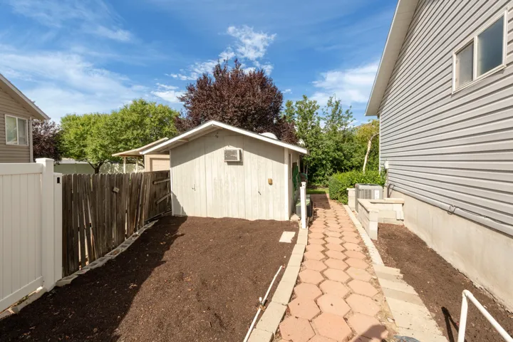Detached storage shed with window air conditioner