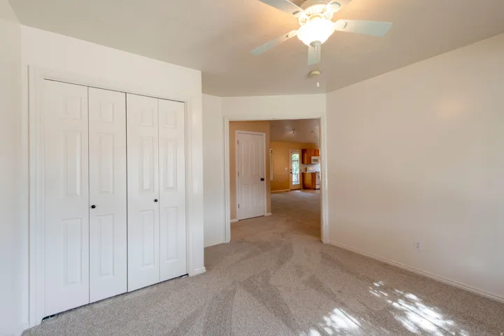 Neutral-toned carpeted flooring complements light wall finishes