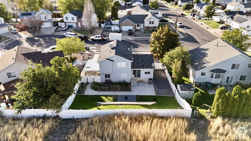 Residential property featuring a two-story structure, fenced backyard, and a paved driveway