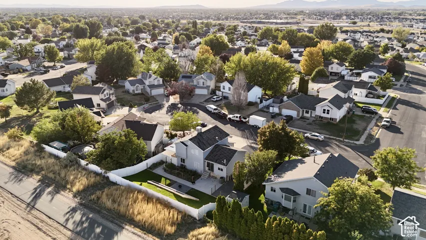 Residential neighborhood with established homes, mature trees, and paved roads