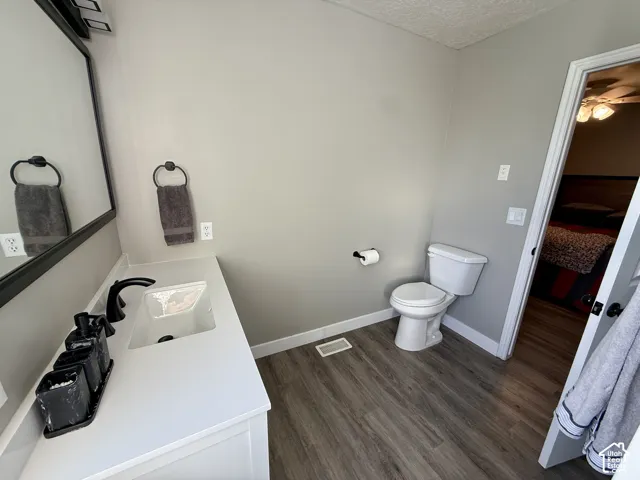 Vanity with white countertop, undermount sink, and matte black faucet