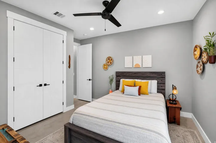 White interior doors with matte black hardware, recessed lighting, and a ceiling fan