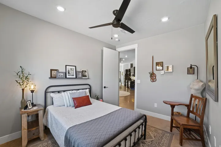 Recessed lighting, ceiling fan, neutral wall tones, and wood-finish flooring