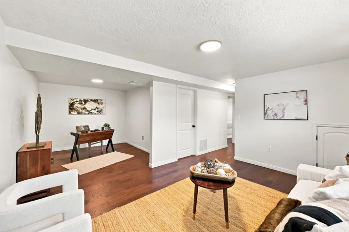 Wood-finish flooring, recessed lighting, and white walls