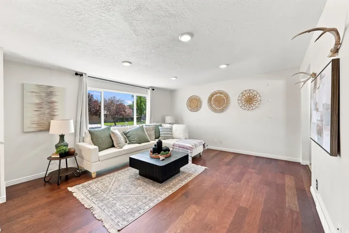 Hardwood flooring, recessed lighting, large window, and light neutral wall colors