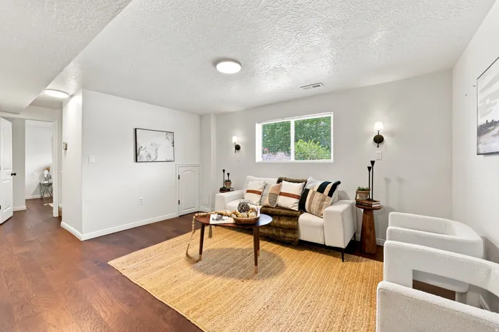 Hardwood-finish flooring, recessed lighting, and wall-mounted sconces