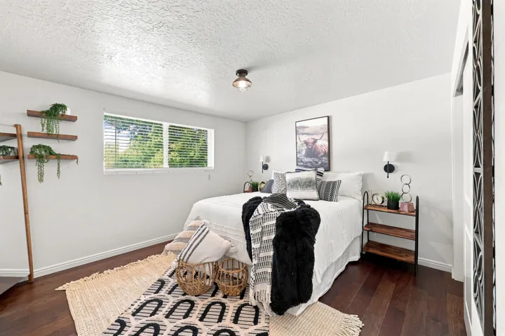 Hardwood-finish flooring, white walls, and a window with blinds