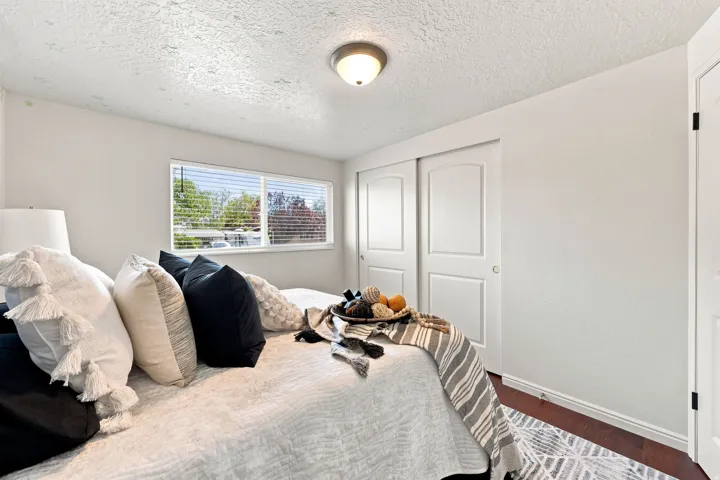 Recessed lighting, wood-finish flooring, and white walls
