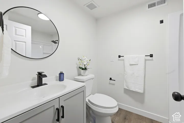 White vanity with integrated sink, matte black faucet, and cabinet storage