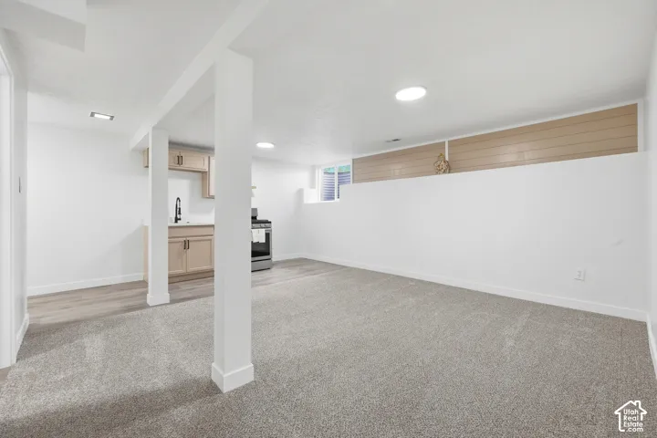 Open-concept room featuring carpeted flooring and recessed lighting