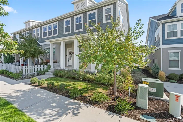 Two-story townhome with light gray siding and white trim