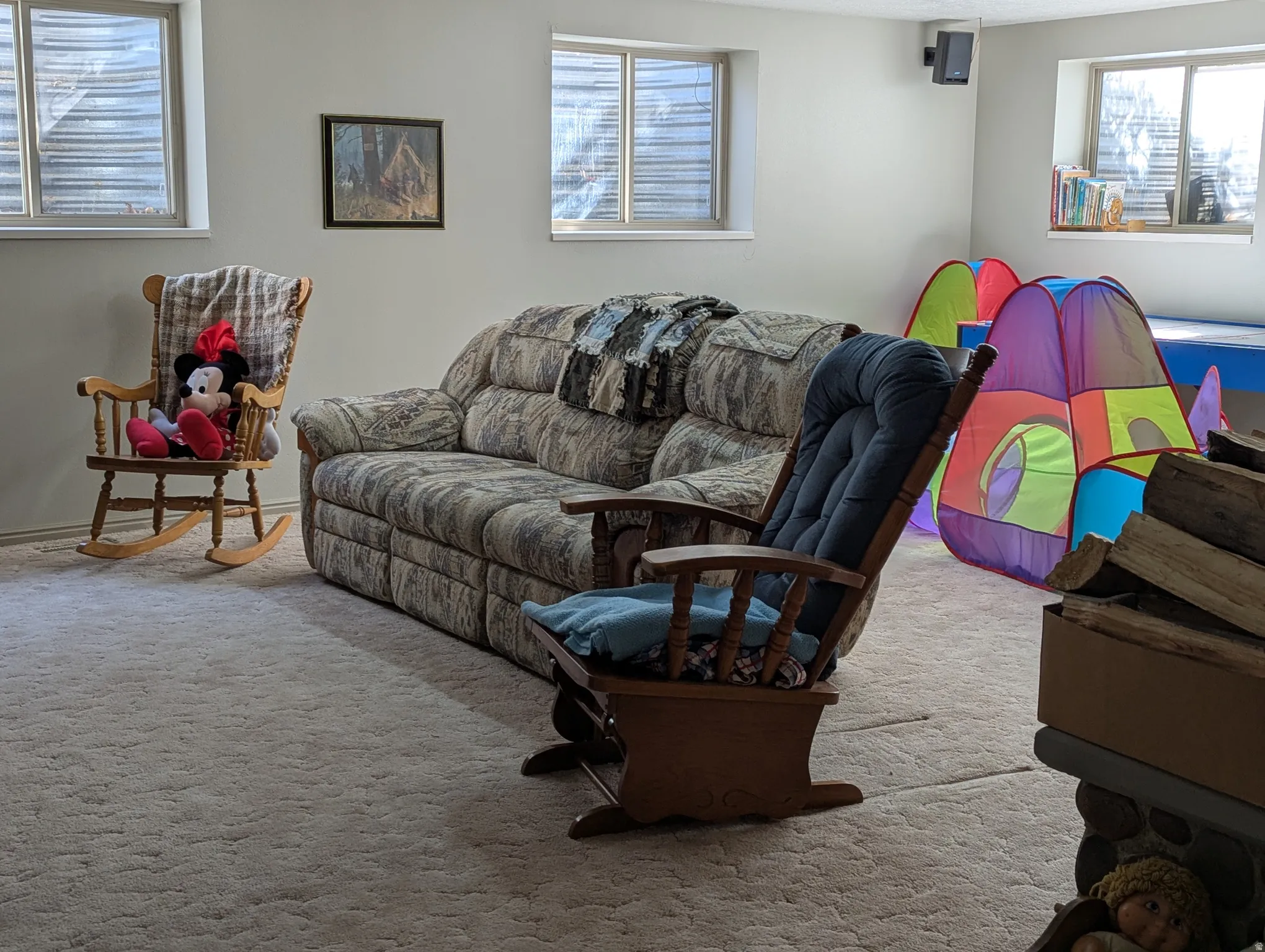 Carpeted room with multiple windows and light-colored walls